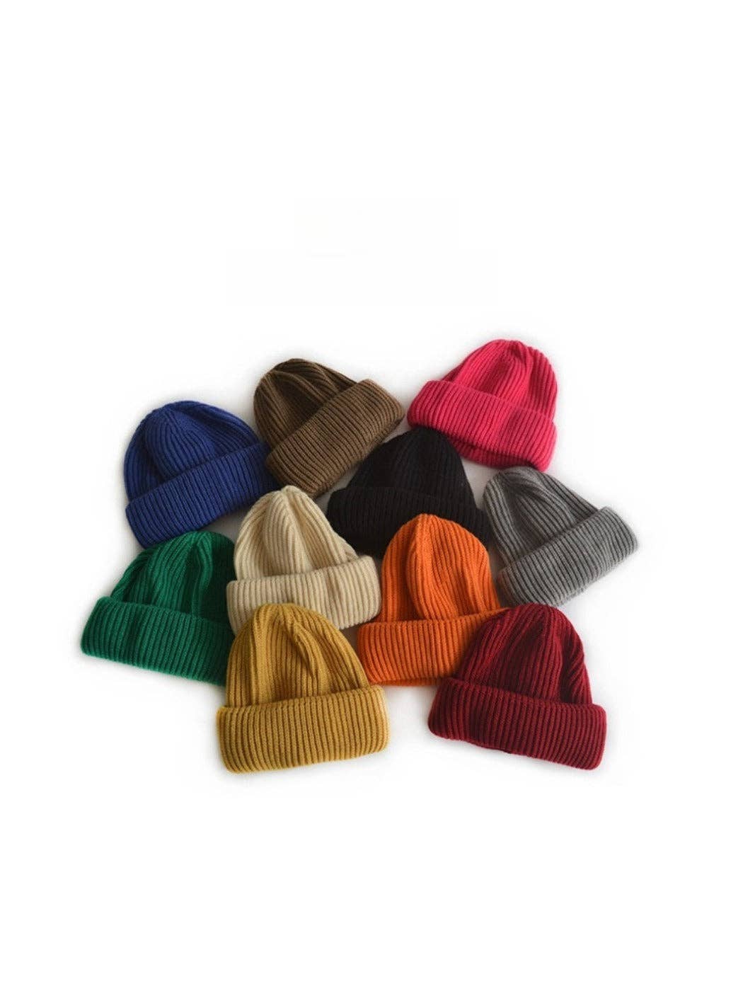 Collection of colorful knit beanie hats on a white background