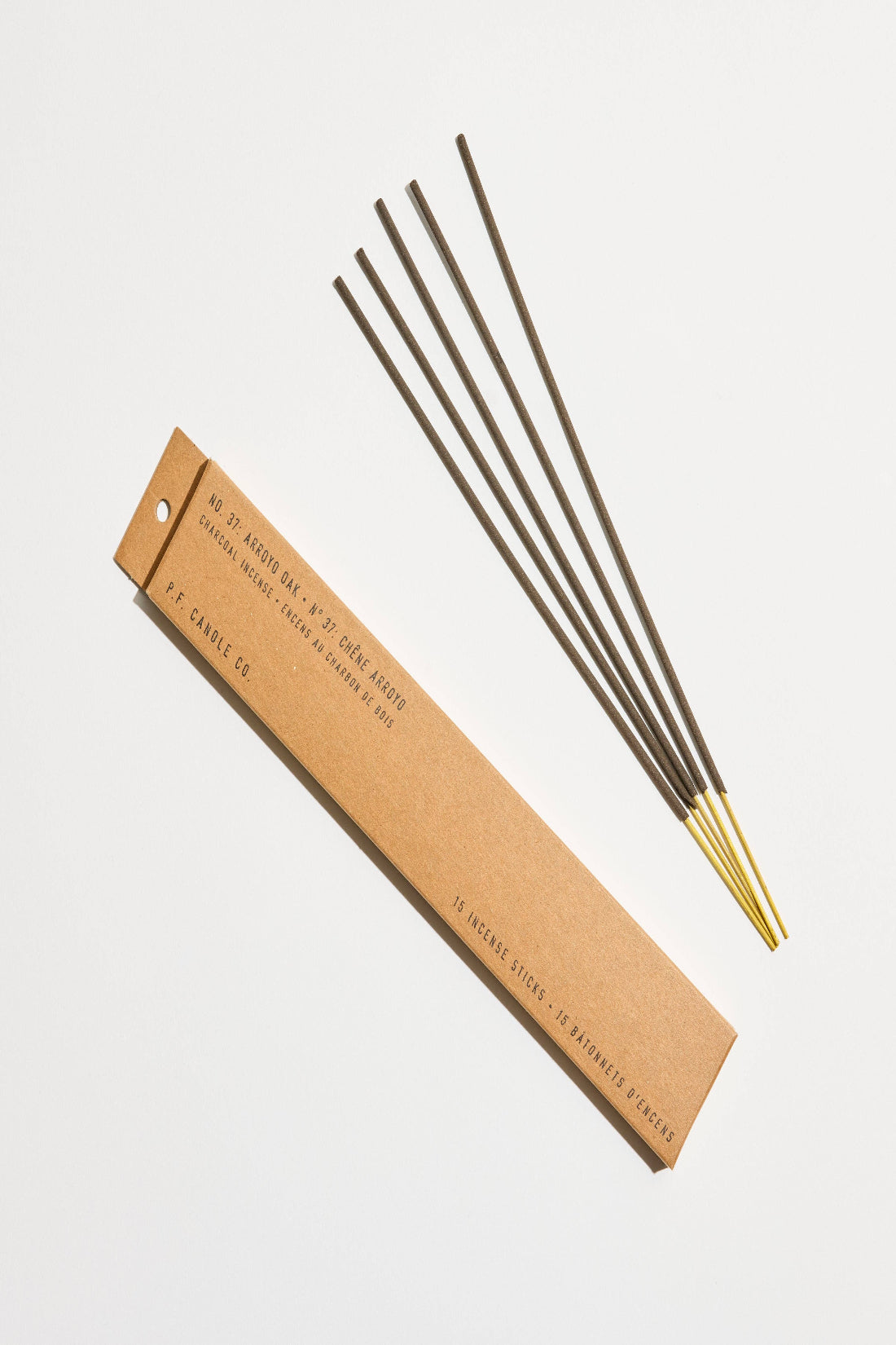 Incense sticks with a cardboard packaging on a light gray background