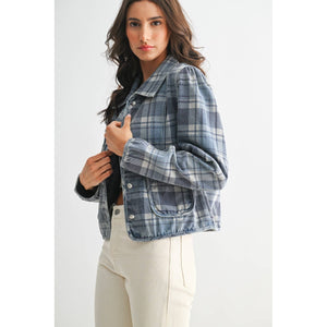 Woman wearing a blue plaid jacket on a white background