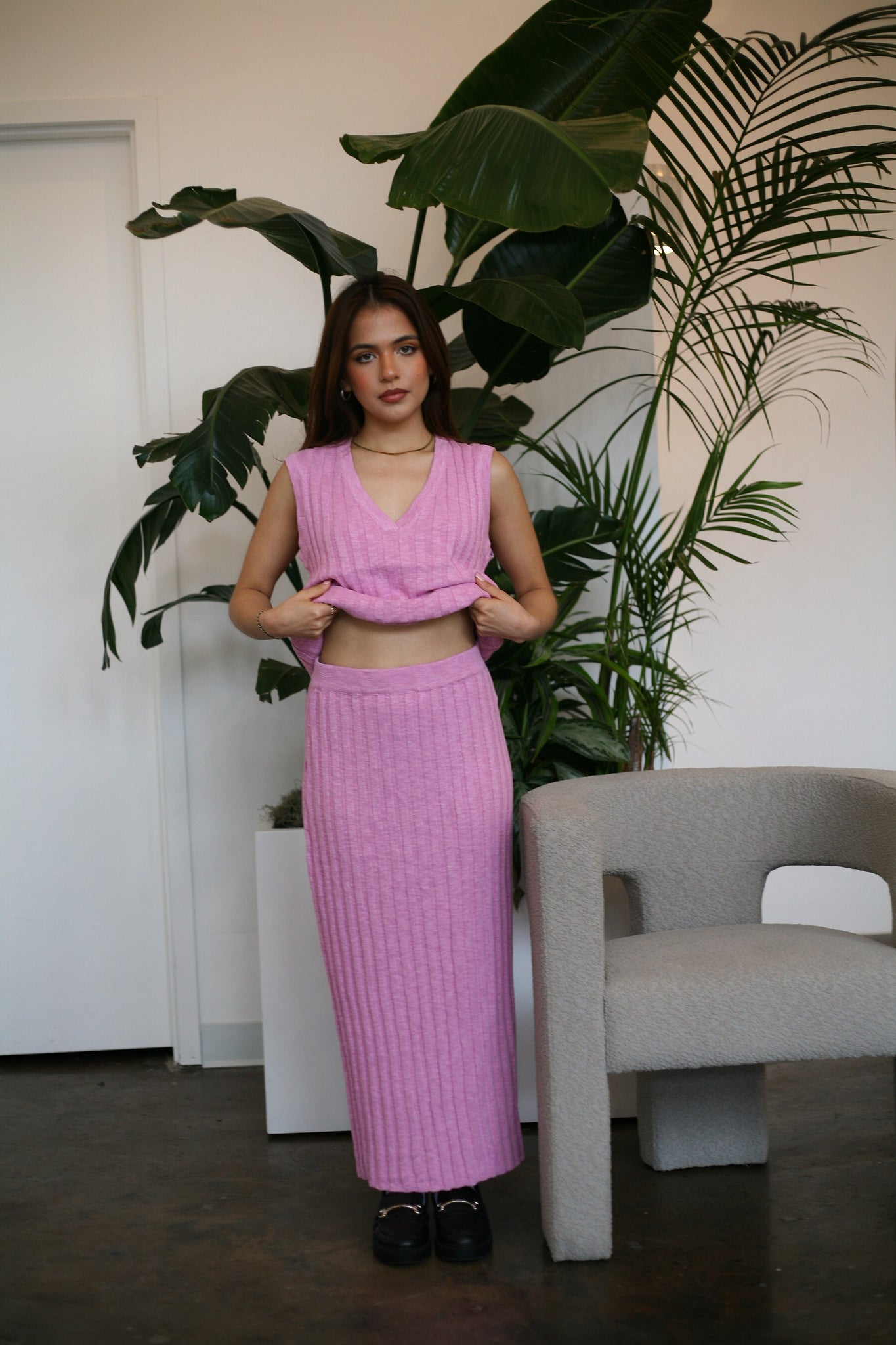 Woman standing wearing pink knit clothing set